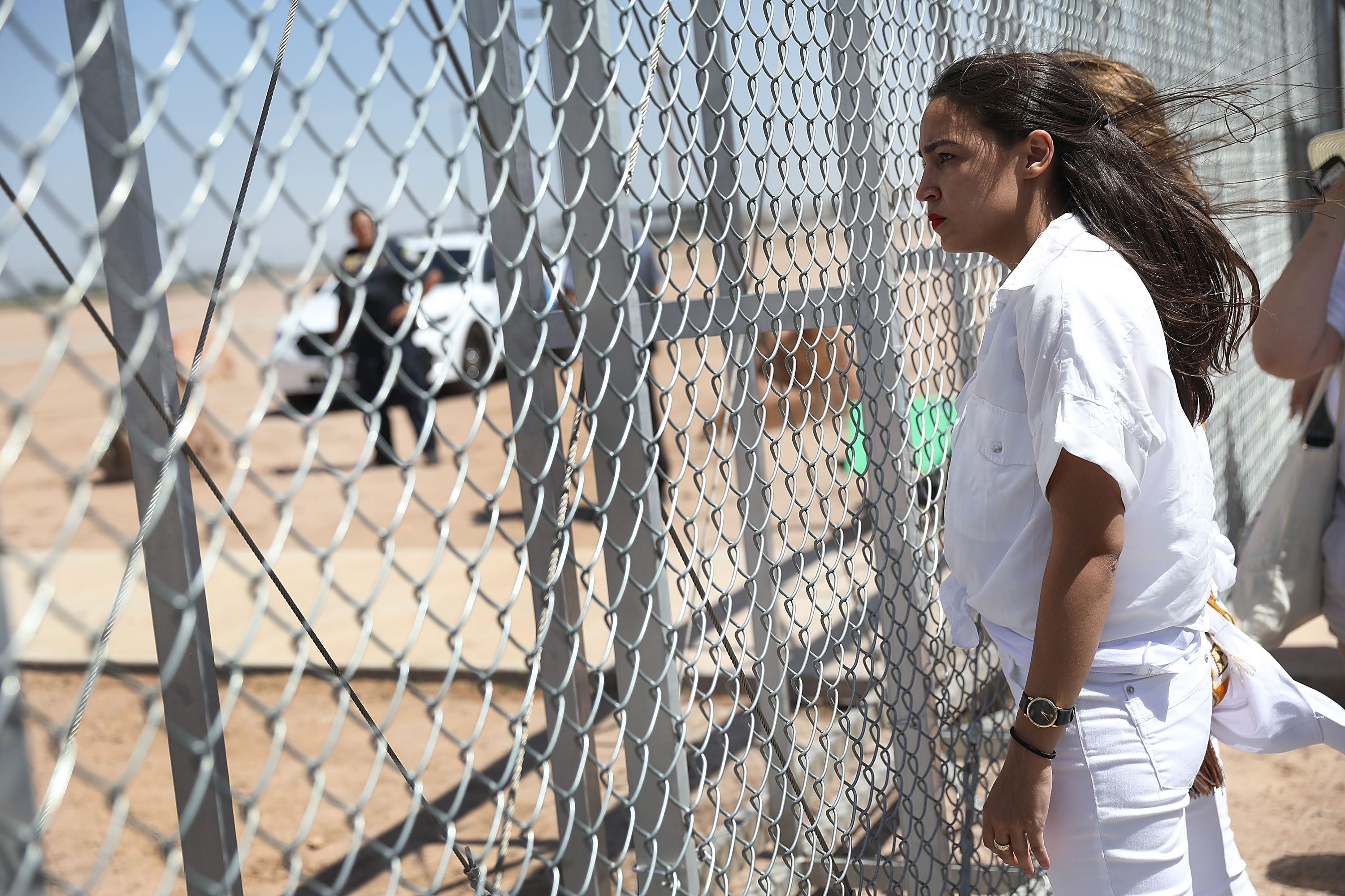 TORNILLO, TX - JUNE 24: Alexandria Ocasio-Cortez stands at the Tornillo-Guadalupe port of entry gate on June 24, 2018 in Tornillo, Texas. She is part of a group protesting the separation of children from their parents after they were caught entering the U.S. under the administration's zero tolerance policy. (Photo by Joe Raedle/Getty Images)